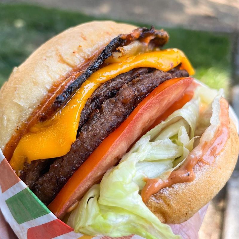 Burger Patch  beyond vegetarian burger with tomatoes lettuce mustard and ketchup